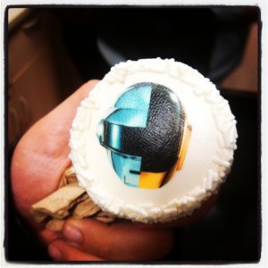 a coworker holding a cupcake from the album release party in NYC